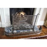 An 18th century cut steel fender together with a wrought iron fire guard,