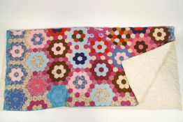 A 1950's hand stitched patchwork quilt,