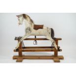 An early 20th century carved wood and painted rocking horse, with horsehair mane and tail,