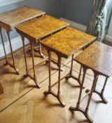 A 19th century walnut nest of four tables on turned tapering legs with splayed feet,