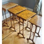 A 19th century walnut nest of four tables on turned tapering legs with splayed feet,