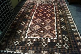 A Kilim rug with central repeating lozenge panel within multiple borders,