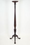 A mahogany torchere, ex a late 18th century tester bed,