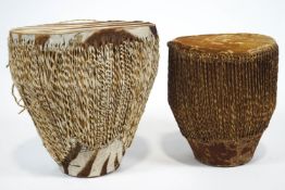 Two African drums, the largest with zebra skin,
