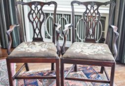 A pair of George III mahogany elbow chairs with pierced inter-linked splats,