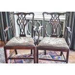 A pair of George III mahogany elbow chairs with pierced inter-linked splats,