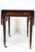 A Mahogany Pembroke table with a plain rectangular top over a drawer with brass ring pull handles,
