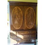 A George III mahogany linen press with satinwood stringing and three graduated drawers,