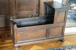 An 18th century oak child's cradle with triple panelled sides,