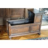 An 18th century oak child's cradle with triple panelled sides,