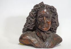 A clay bust of an 18th century gentleman in a large curled wig,