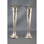 A pair of loaded silver trumpet form spill vases, with petal form rims, Birmingham 1905,