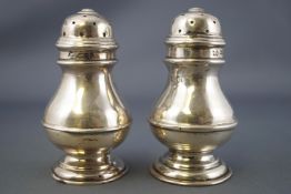 A pair of silver peppers and salts, the peppers of plain George I baluster form, London 1902,