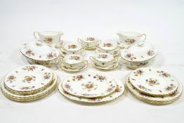 A Minton bone china dinner service of swirling design, decorated in the Marlow pattern,