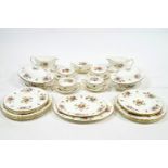 A Minton bone china dinner service of swirling design, decorated in the Marlow pattern,