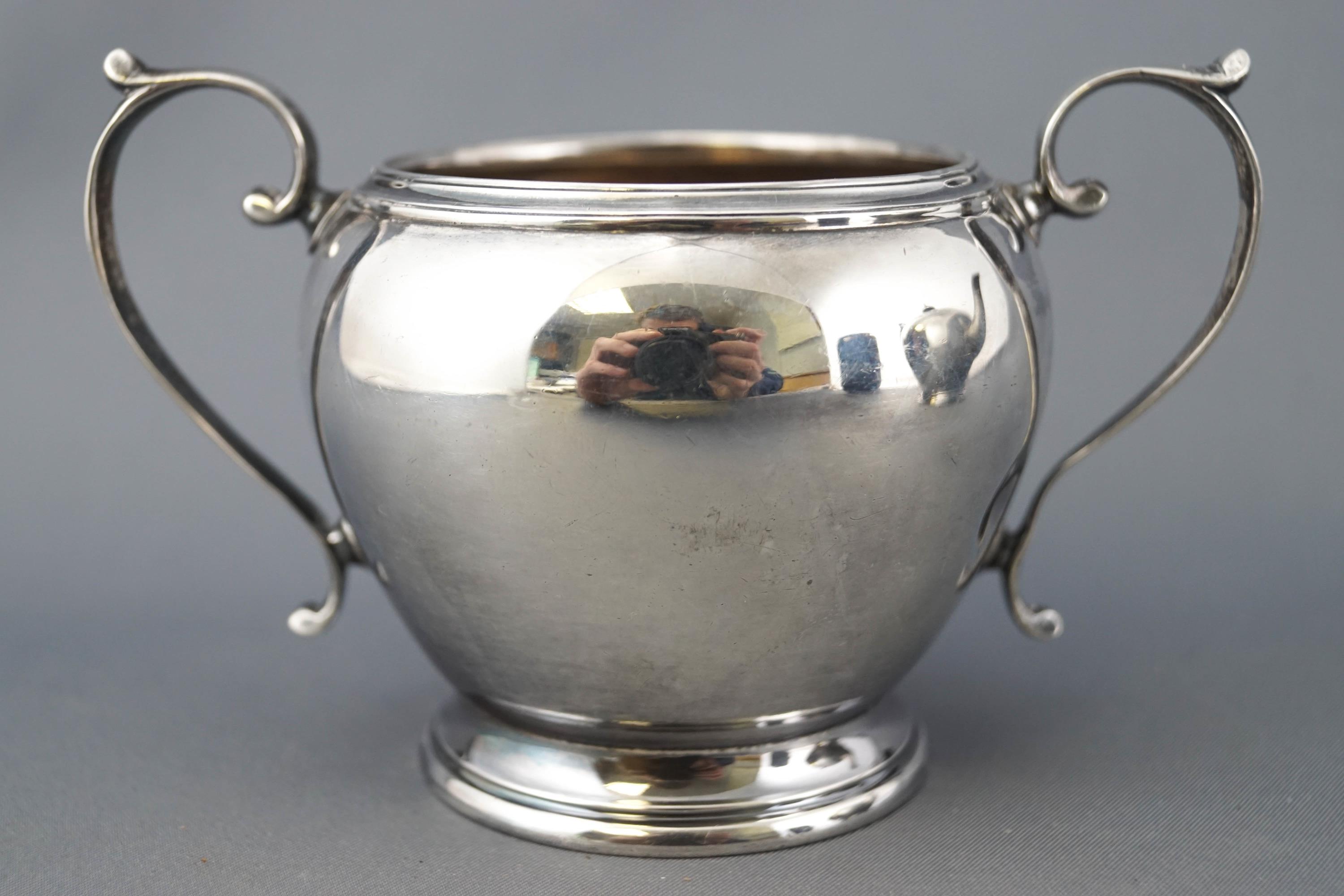 A silver three piece tea service of plain rounded form, with reeded tops and bases, - Image 4 of 5