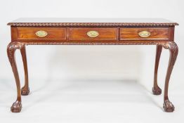 A mahogany desk in George III style, with three frieze drawers,