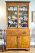 An early 19th century mahogany secretaire bookcase with two astragal glazed doors