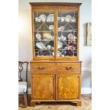 An early 19th century mahogany secretaire bookcase with two astragal glazed doors