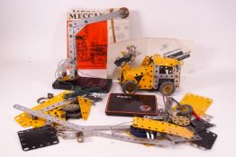 A group of Meccano items together with magazines 0-1 and 2/3
