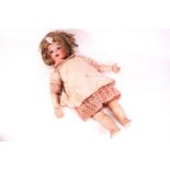 A 19th century porcelain doll with porcelain sleeping eye, head numbered 32,