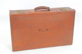 A vintage leather suitcase with English lever brass locks and LNER and GWR train labels,