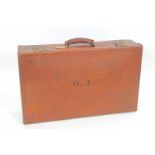 A vintage leather suitcase with English lever brass locks and LNER and GWR train labels,