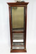A mahogany framed display cabinet with glass shelves,
