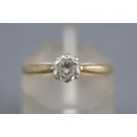 A yellow metal single stone ring. Set with a round brilliant cut diamond of approximately 0.46cts.