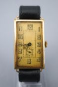 A rolled gold wristwatch. Rectangular hinged case. Manual wind (unsigned) movement.
