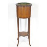 An Edwardian mahogany shaped square plant stand,