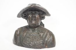 A bust of an 18th century gentleman, in a tricorn hat and fancy wig,