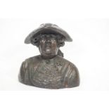 A bust of an 18th century gentleman, in a tricorn hat and fancy wig,