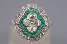 A white metal dress ring. Principally set with four old European cut diamonds