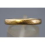 A yellow metal 3.5mm court shaped wedding ring. Hallmarked 22ct gold, Birmingham, 1926. Size N