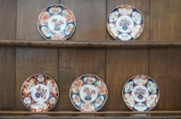 A set of four Japanese porcelain lobed plates, painted in an Imari pattern,