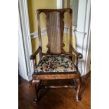 A George III mahogany elbow chair with pierced splat and drop in seat on cabriole legs
