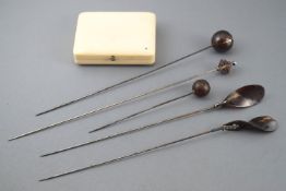 An (?) ivory cheroot case and a group of pique hatpins