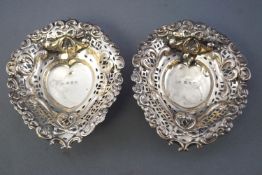 A pair of silver bonbon dishes, of heart shape design, with pierced and repousse decoration,