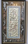 A pair of Chinese silk pictures, each embroidered with bird on branches within a black border,