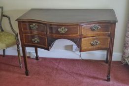 A George III mahogany serpentine fronted dressing table with satinwood cross banding