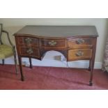 A George III mahogany serpentine fronted dressing table with satinwood cross banding