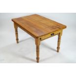 A pine table with one frieze drawer on turned legs,