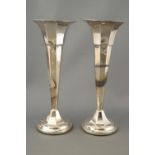 A pair of silver spill vases, of loaded form, designed as octagonal trumpets, Sheffield 1920,