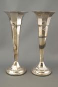 A pair of silver spill vases, of loaded form, designed as octagonal trumpets, Sheffield 1920,