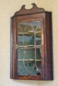 A George III mahogany corner cabinet with glazed door,