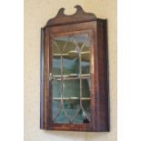 A George III mahogany corner cabinet with glazed door,