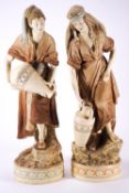A pair of Royal Dux figures of water carriers,