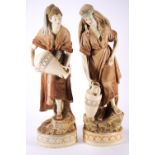 A pair of Royal Dux figures of water carriers,