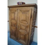 An 18th century Continental armoire, with two multi panelled doors on strap hinges,